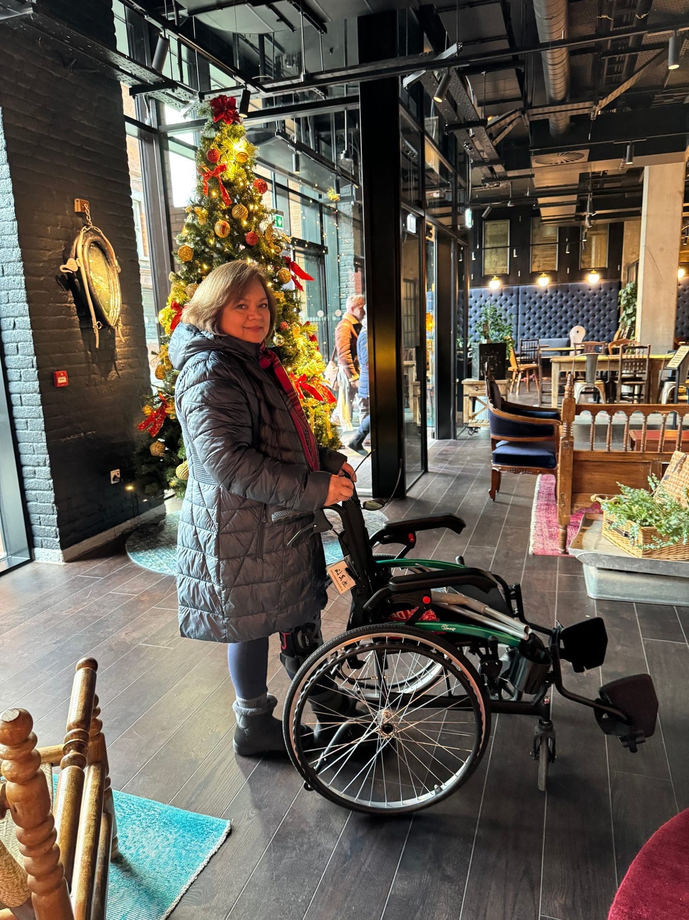 A guest at a Dublin hotel reception with a rented lightweight wheelchair from Emerald Rentals.