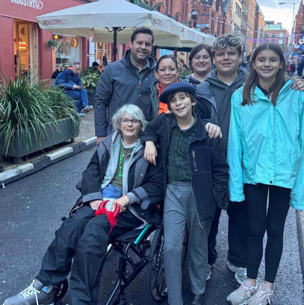 Family enjoying a day out in Dublin with grandmother in rented ultralight wheelchair